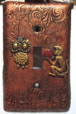 A puzzled steampunk owl being offered fruit by a monkey